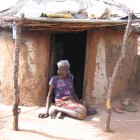 Amina Wumbala in front of her hut